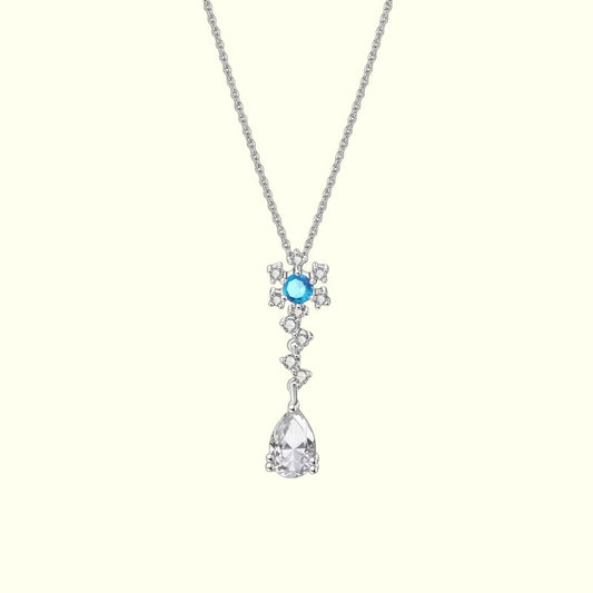 Silver necklace with a blue gemstone and teardrop pendant on a white background