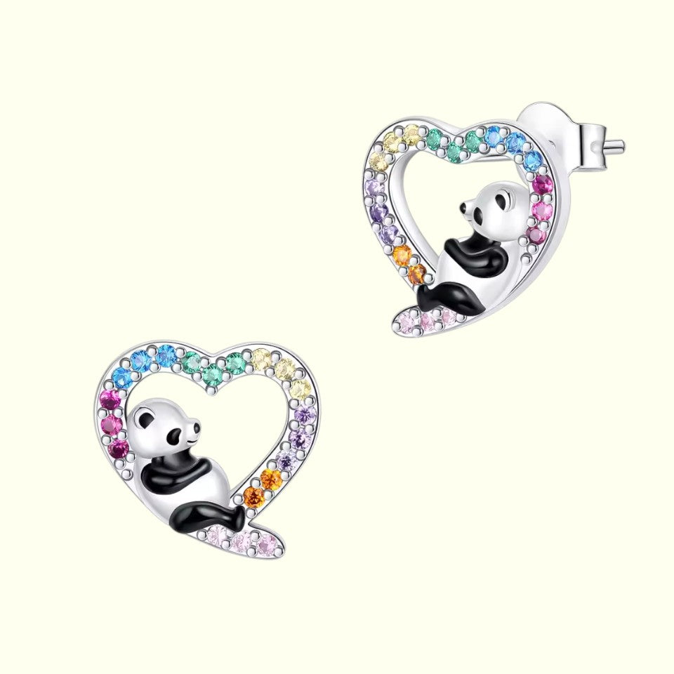 Panda-shaped earrings with heart designs and colorful gemstones on a white background