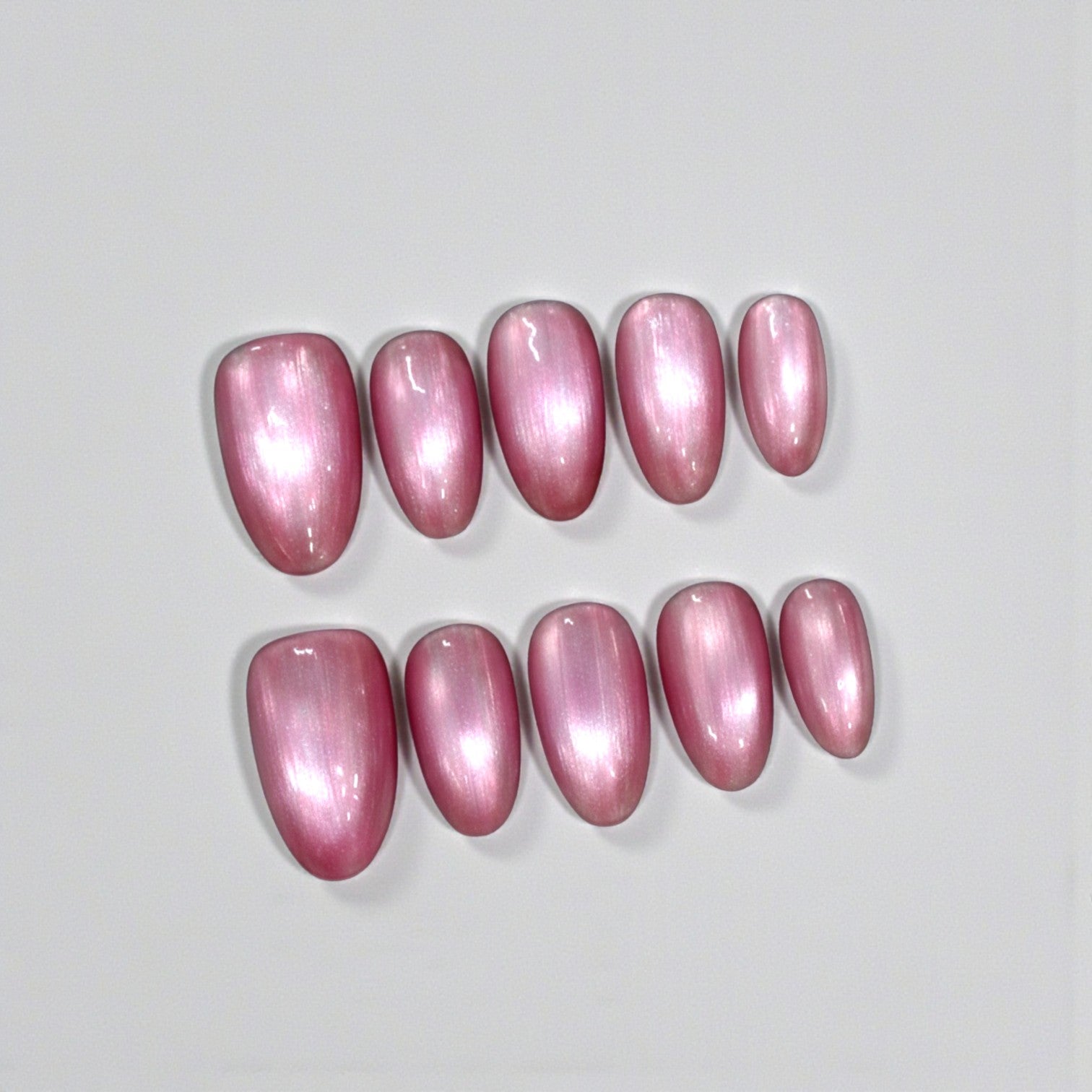 Pink nail polish samples on a light gray background