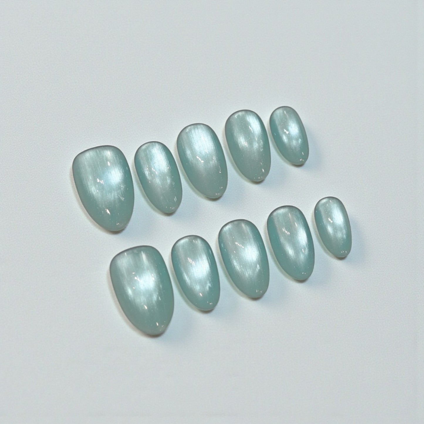 Set of light blue nail polish samples on a white background