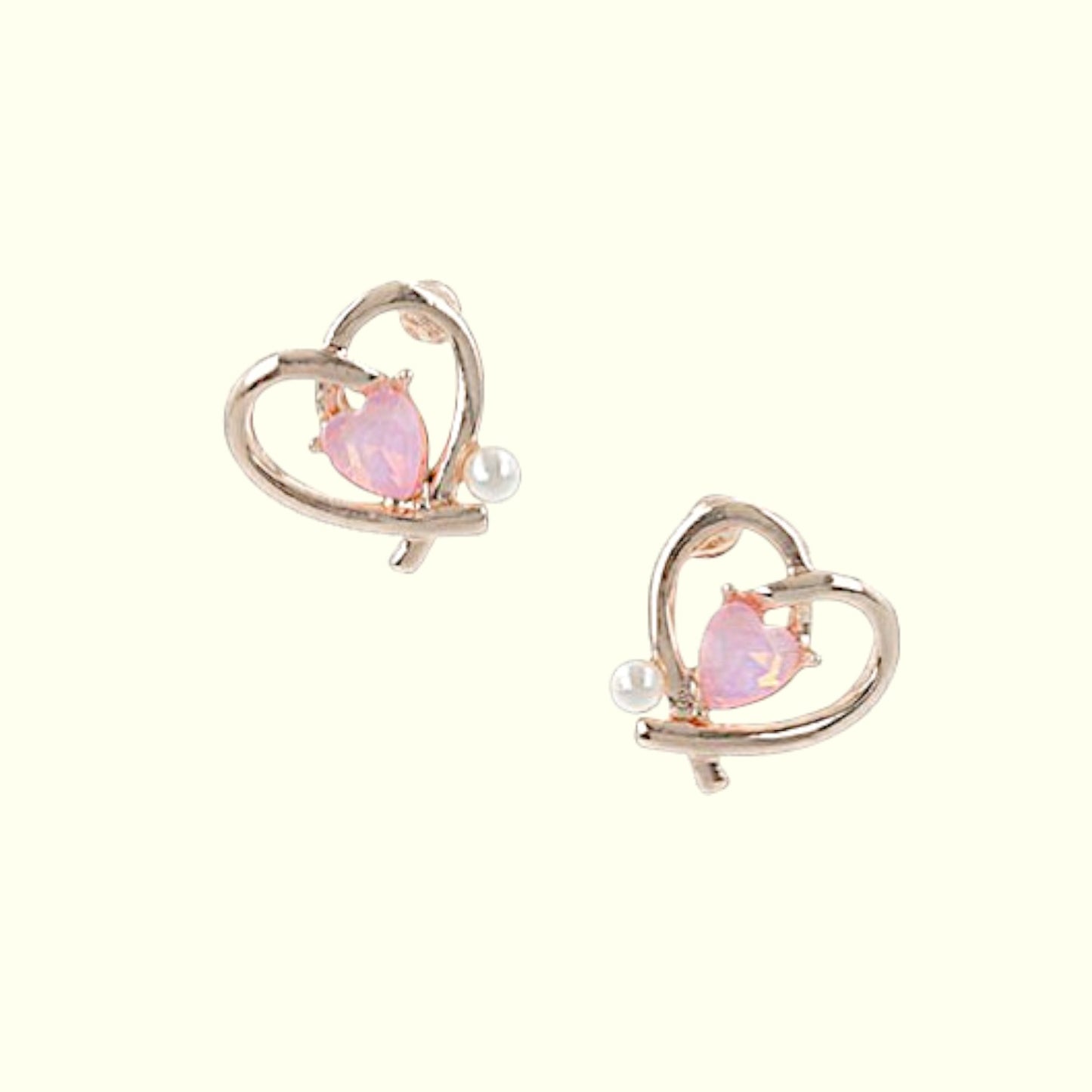 Heart-shaped earrings with pink gemstones and pearl accents on a white background