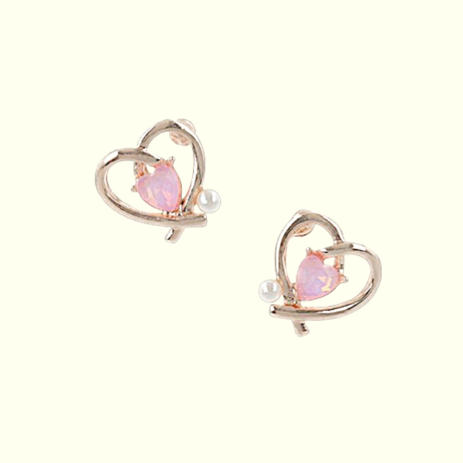 Heart-shaped earrings with pink gemstones and pearl accents on a white background