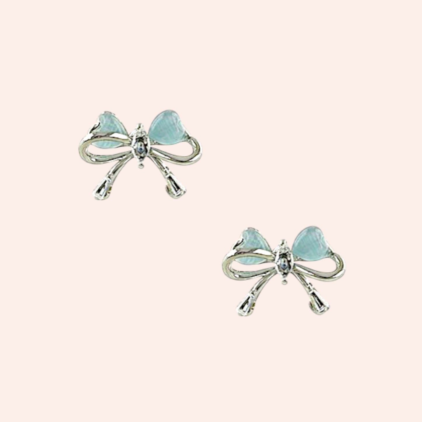 Bow-shaped earrings with light blue gemstones on a white background