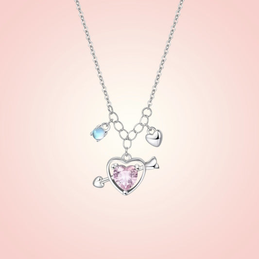 Necklace with heart-shaped pendant and pink gem on a pink gradient background