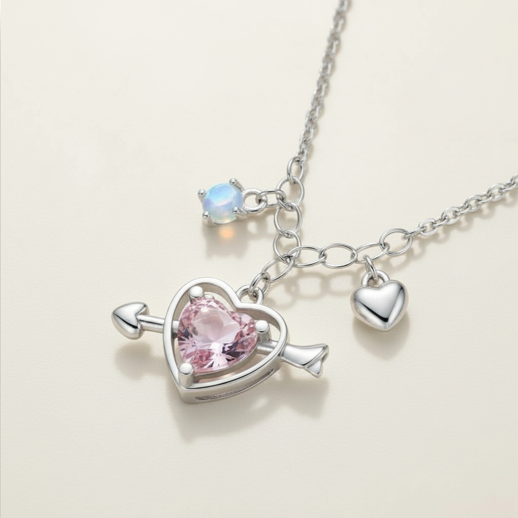 Necklace with heart-shaped pendant and pink gemstone on a light background