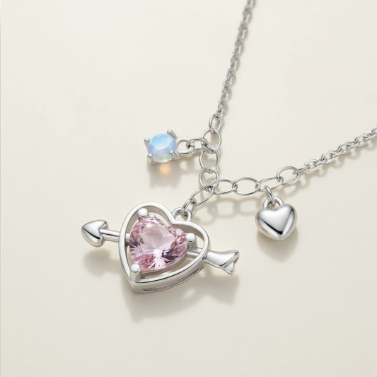 Necklace with heart-shaped pendant and pink gemstone on a light background