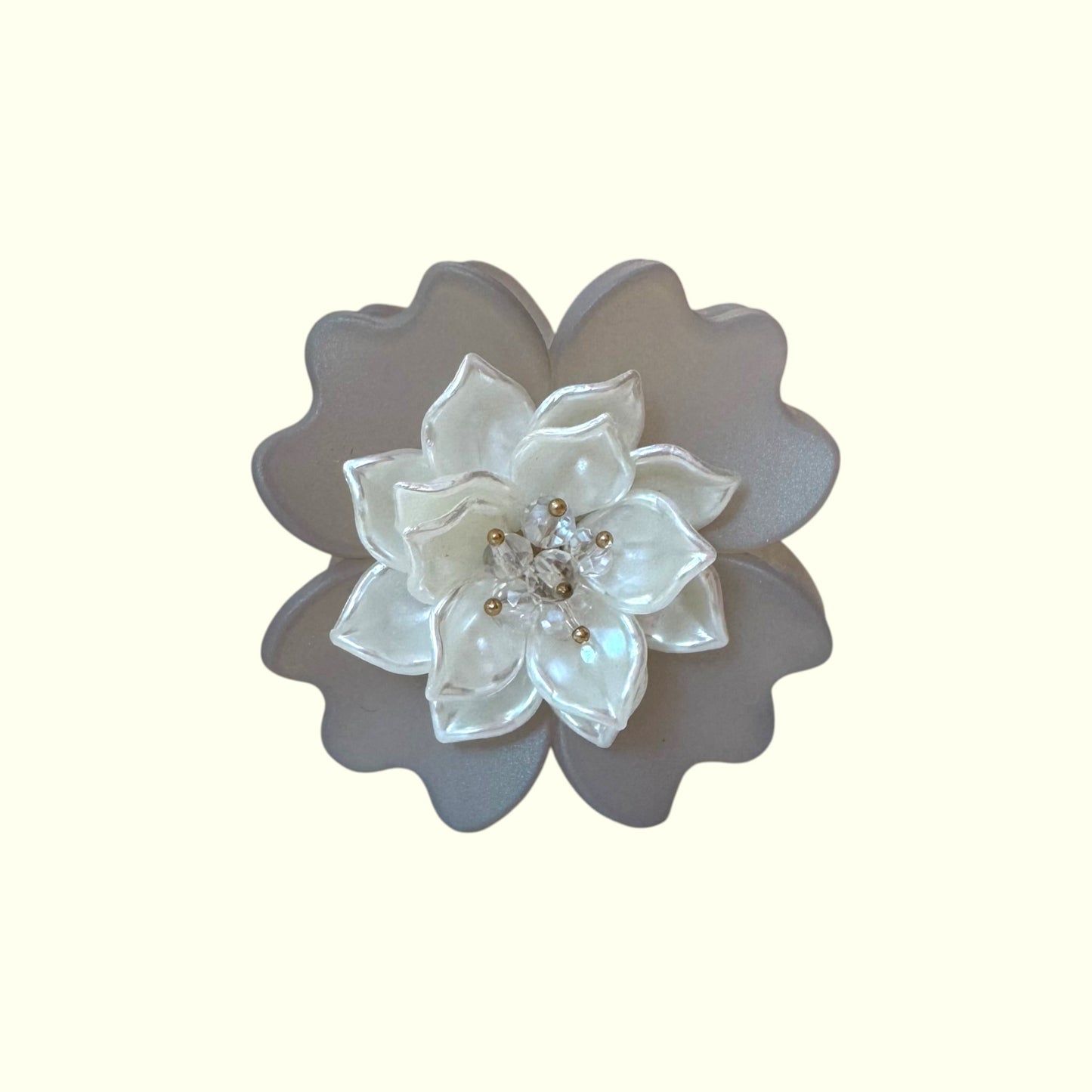 Decorative flower with pearl-like center on a white background