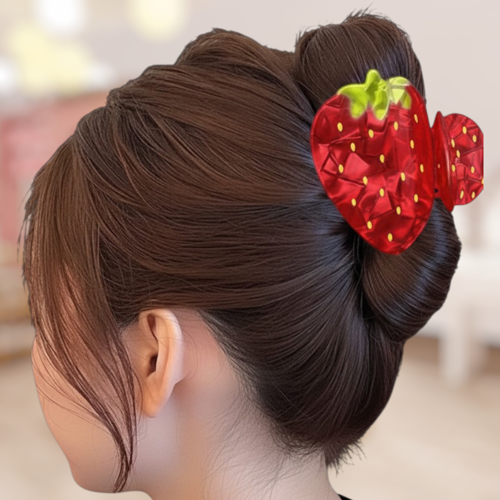 Hair bun with a strawberry hair accessory on a blurred background