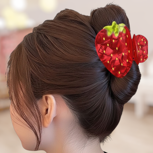Hair bun with a strawberry hair accessory on a blurred background