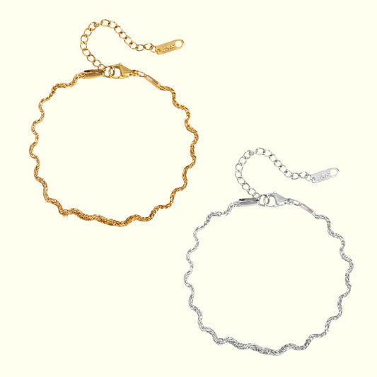 Gold and silver chain bracelets on a white background