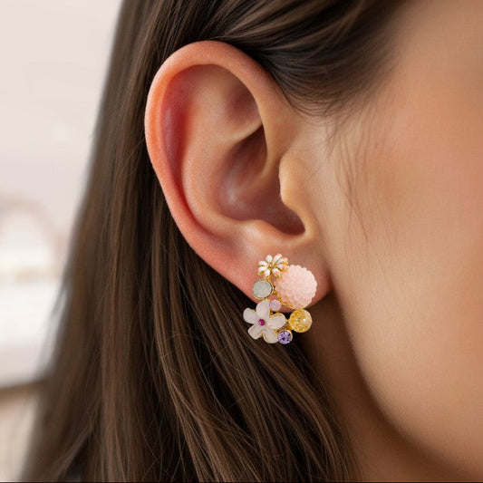 Close-up of an ear wearing a floral earring with multicolored stones.