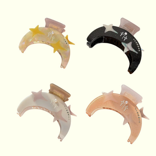 Four hair clips with star designs on a white background