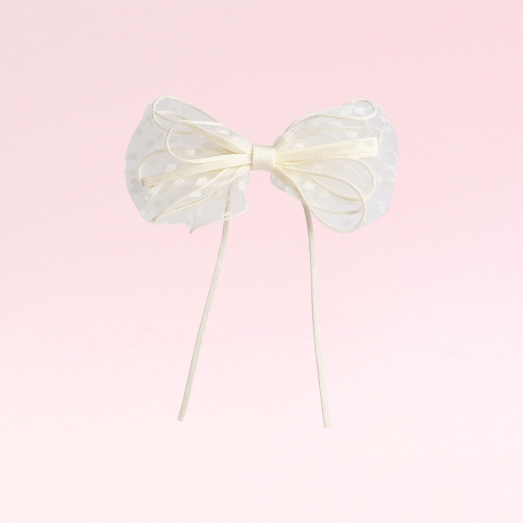 Large white bow on a pink background
