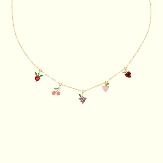Necklace with colorful heart, strawberry, and flower charms on a white background