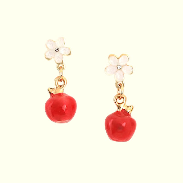 Pair of earrings with red pomegranate-like charms and white floral elements on a white background