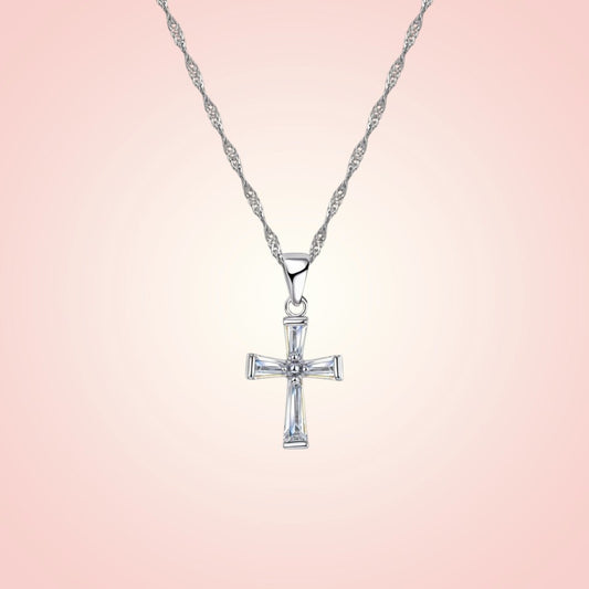 Silver cross pendant necklace on a pink gradient background