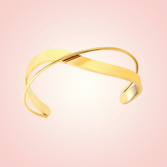 Gold bracelet on a pink background