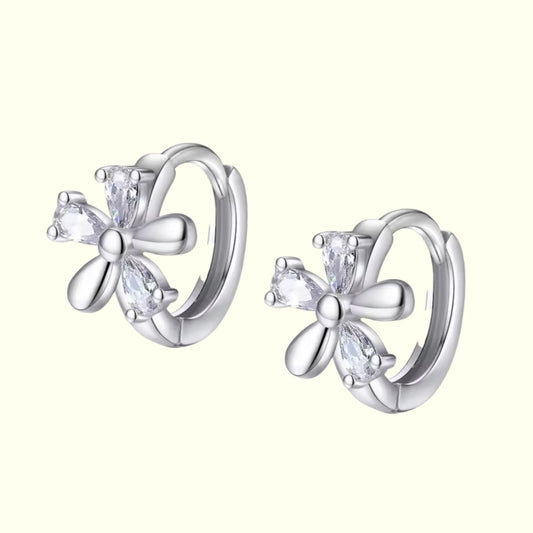 Silver butterfly earrings with clear gemstones on a white background