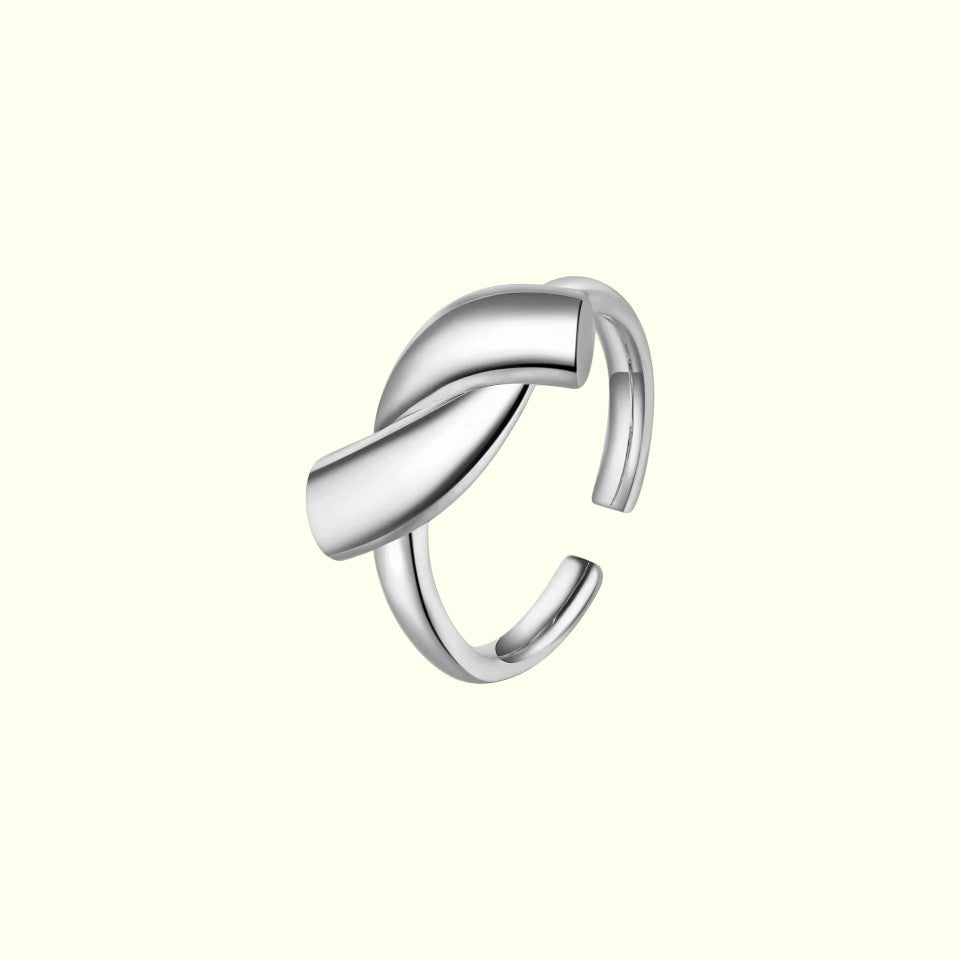 Silver ring with a twisted design on a white background