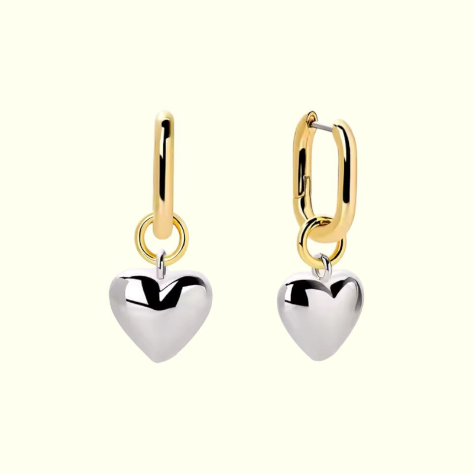 Heart-shaped earrings with gold and silver hooks on a white background