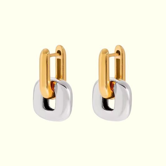 Pair of gold and silver hoop earrings on a white background