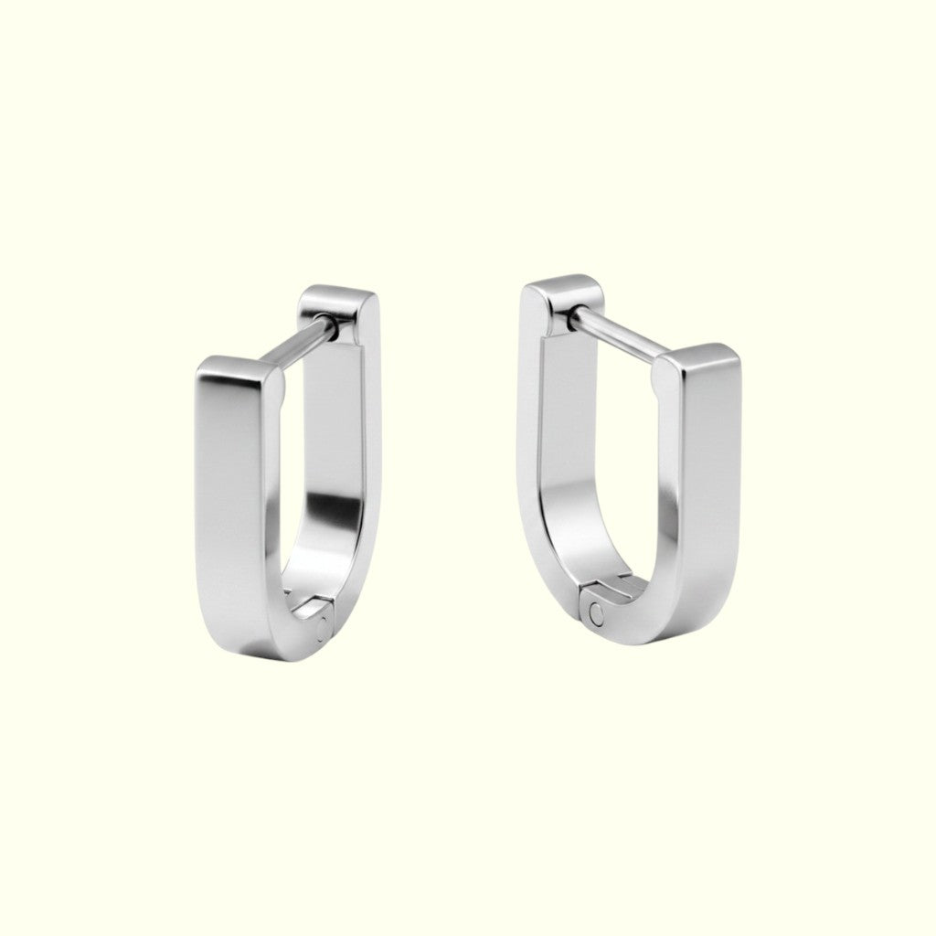 Pair of silver hoop earrings on a white background