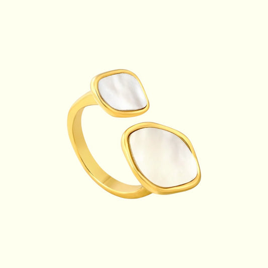 Gold ring with white stone on a white background