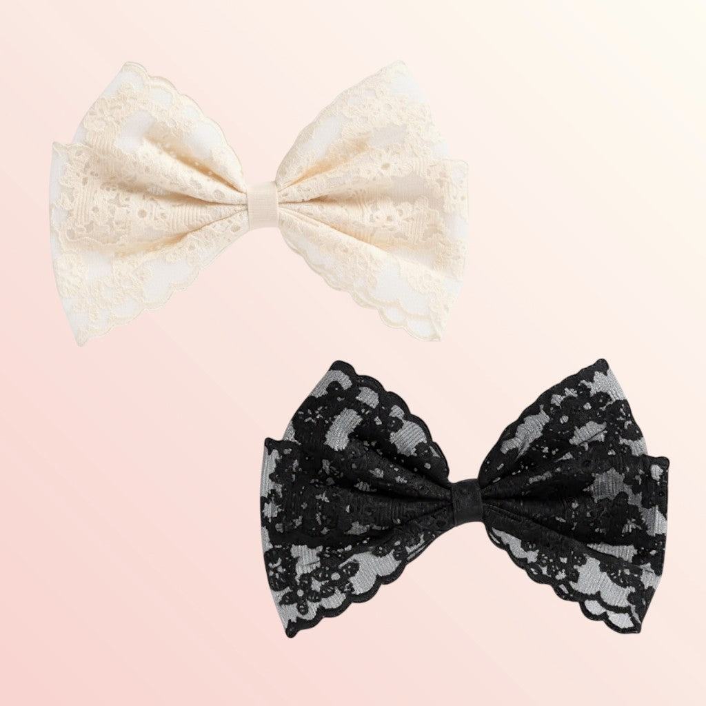Two lace bows, one beige and one black, on a light pink background.