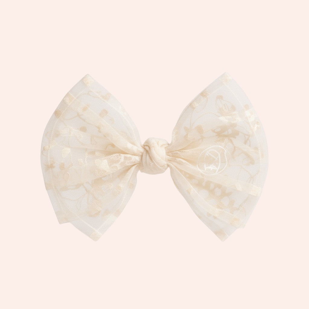Bow-shaped hair accessory with a marble pattern on a white background