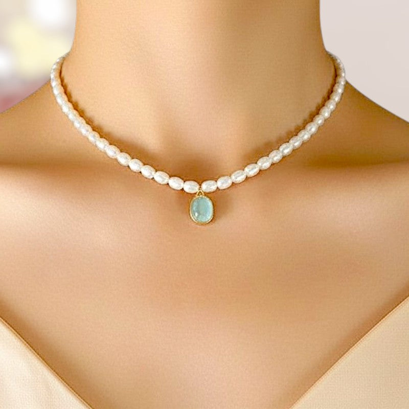 Pearl necklace with a central gemstone on a mannequin