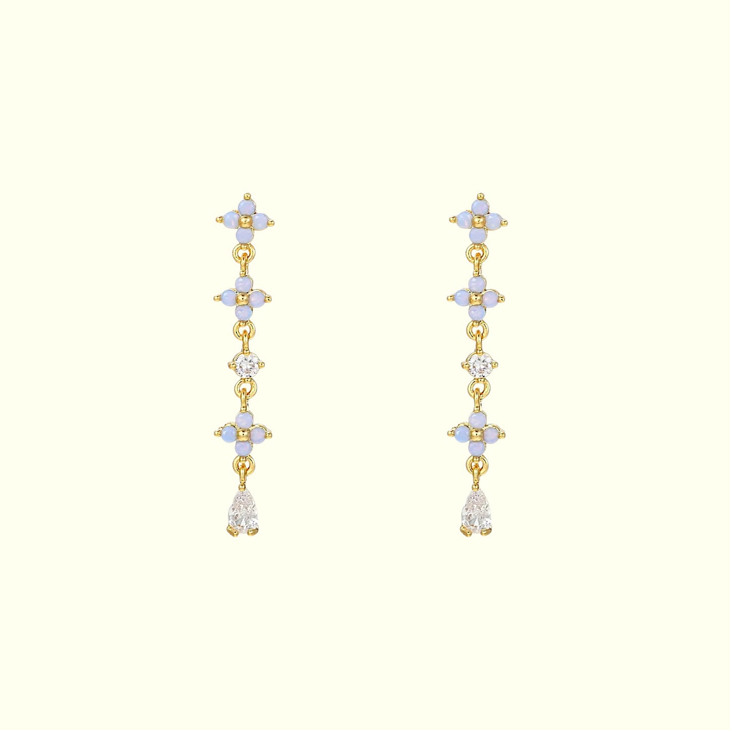 Gold earrings with multiple gemstones on a white background