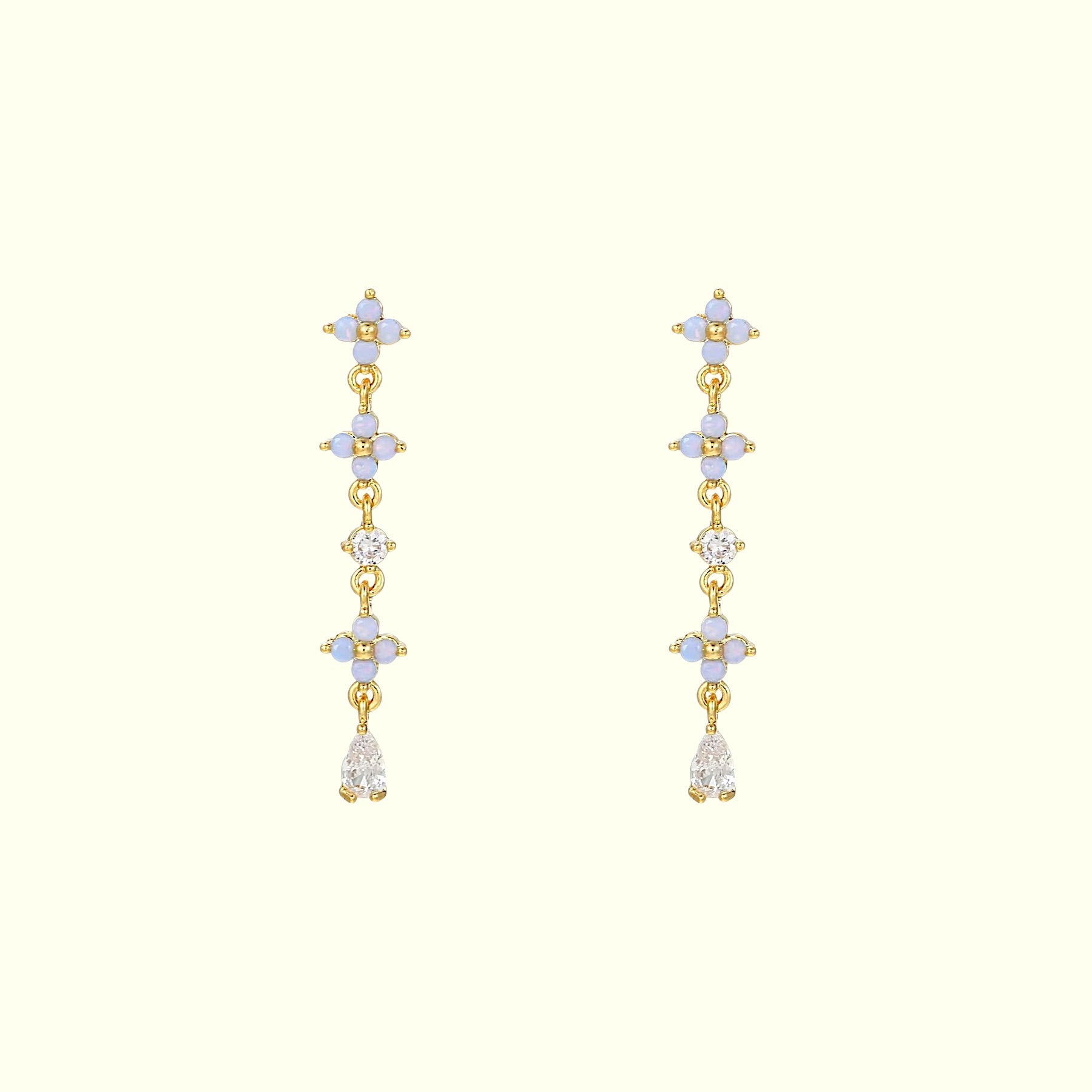 Gold earrings with multiple gemstones on a white background