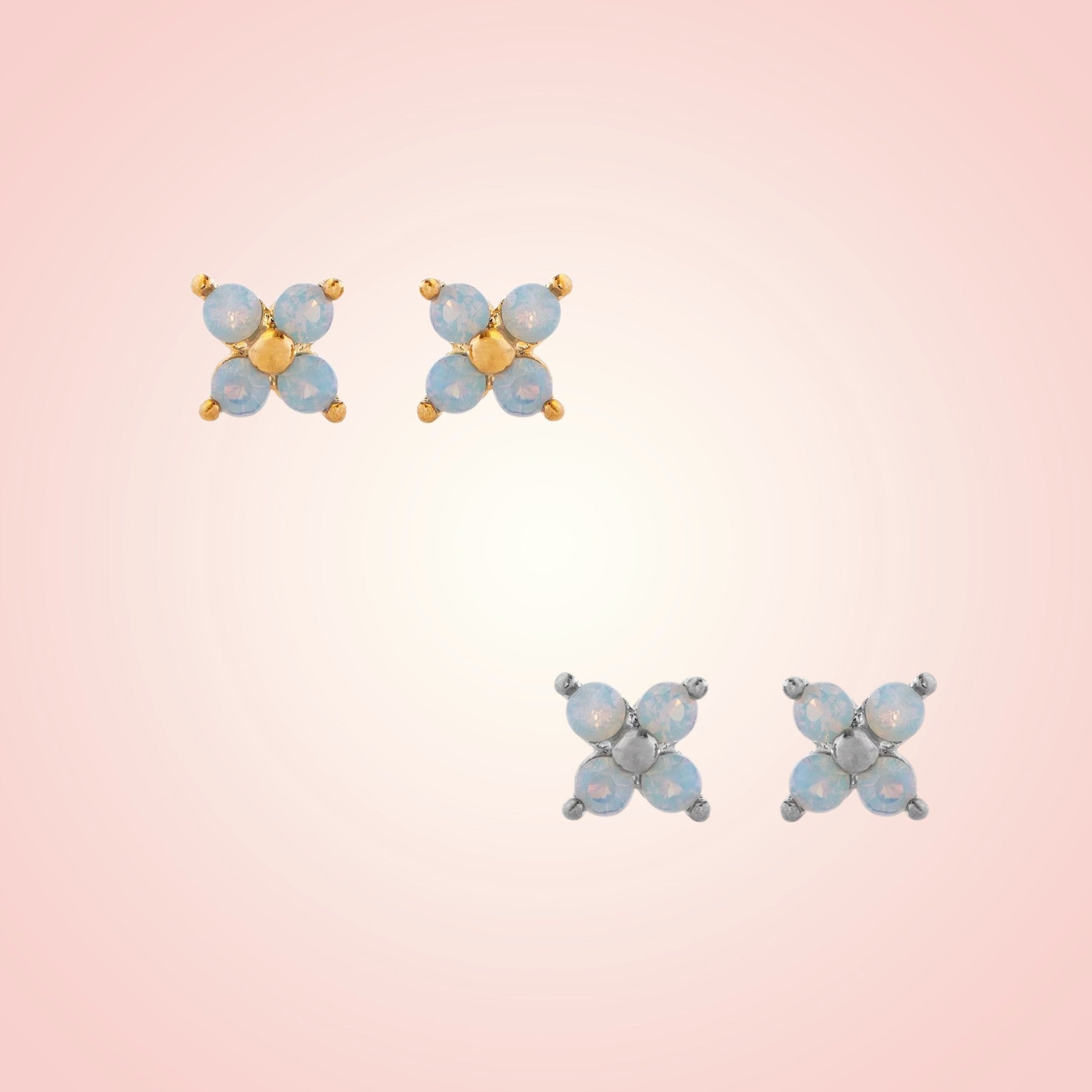 Pair of butterfly-shaped earrings on a gradient pink background