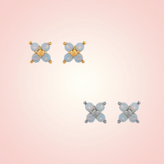 Pair of butterfly-shaped earrings on a gradient pink background