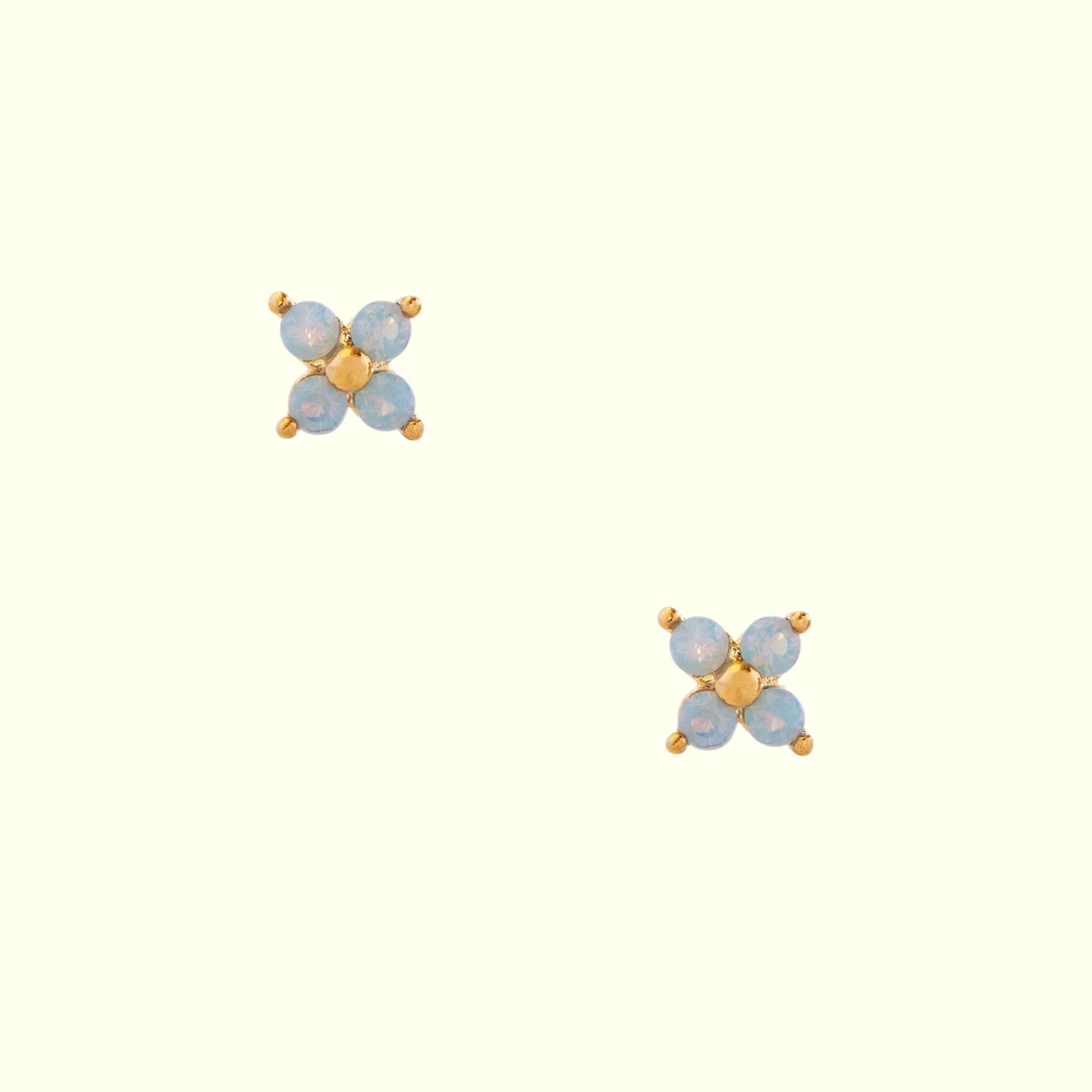 Pair of gold and blue earrings on a white background