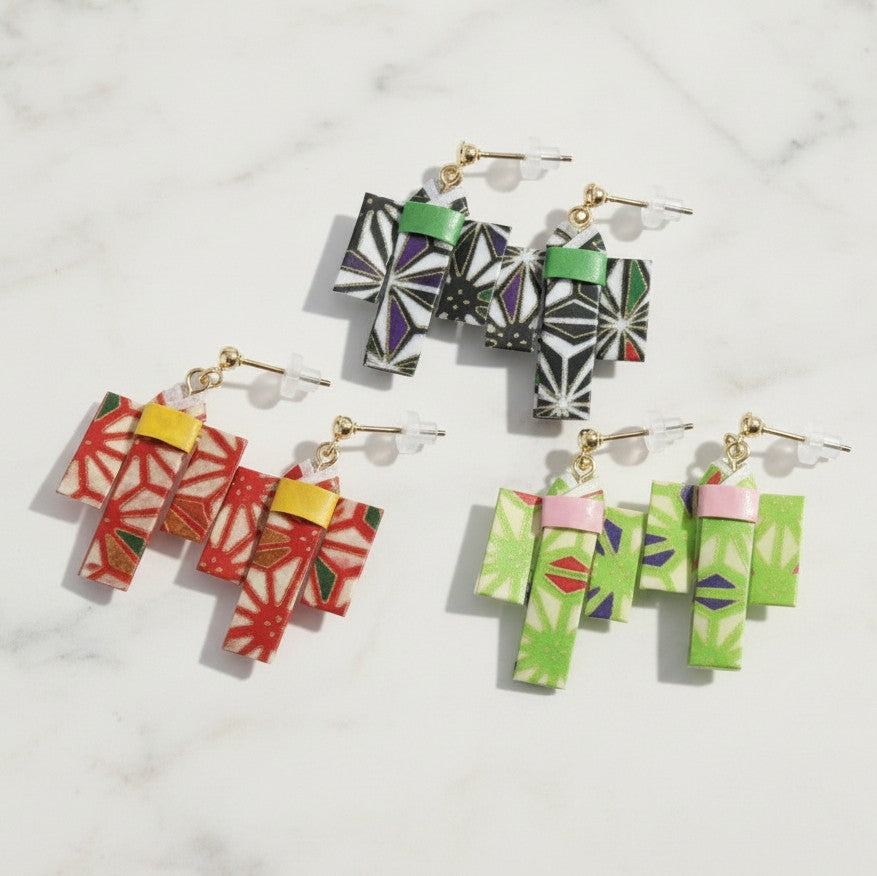 Colorful geometric earrings on a light gray background