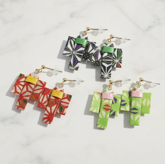 Colorful geometric earrings on a light gray background