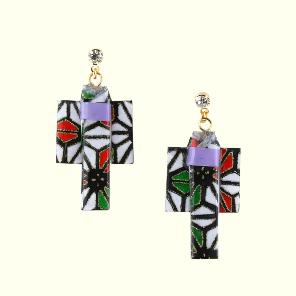 Pair of geometric patterned earrings on a white background