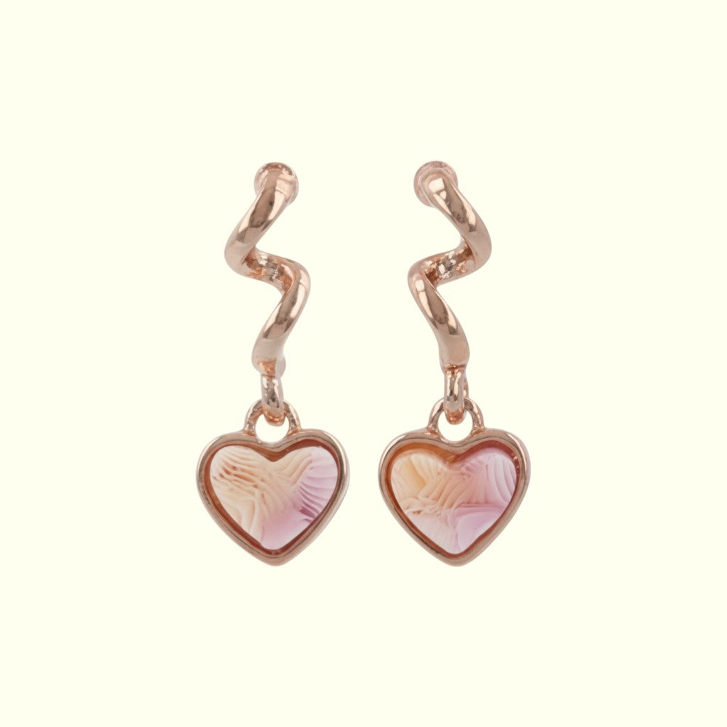 Heart-shaped earrings with rose gold hooks on a white background