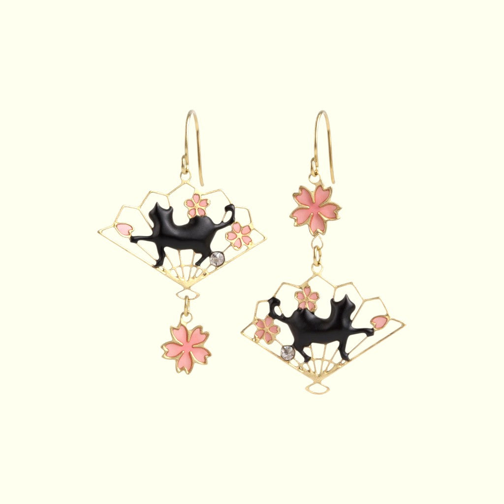 Pair of earrings with black cat and pink flower design on a white background