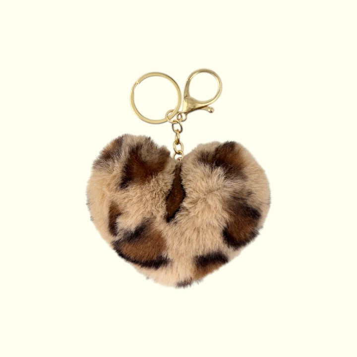 Heart-shaped fur keychain with gold clasp on a white background