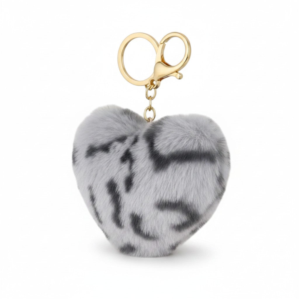 A heart-shaped faux fur keychain charm in gray and black with a gold-tone lobster clasp and split key ring, shown on a plain white background.