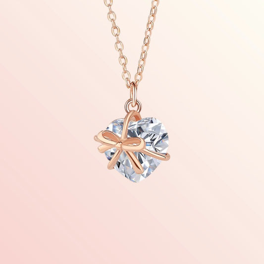 Necklace with a heart-shaped crystal pendant on a light pink background